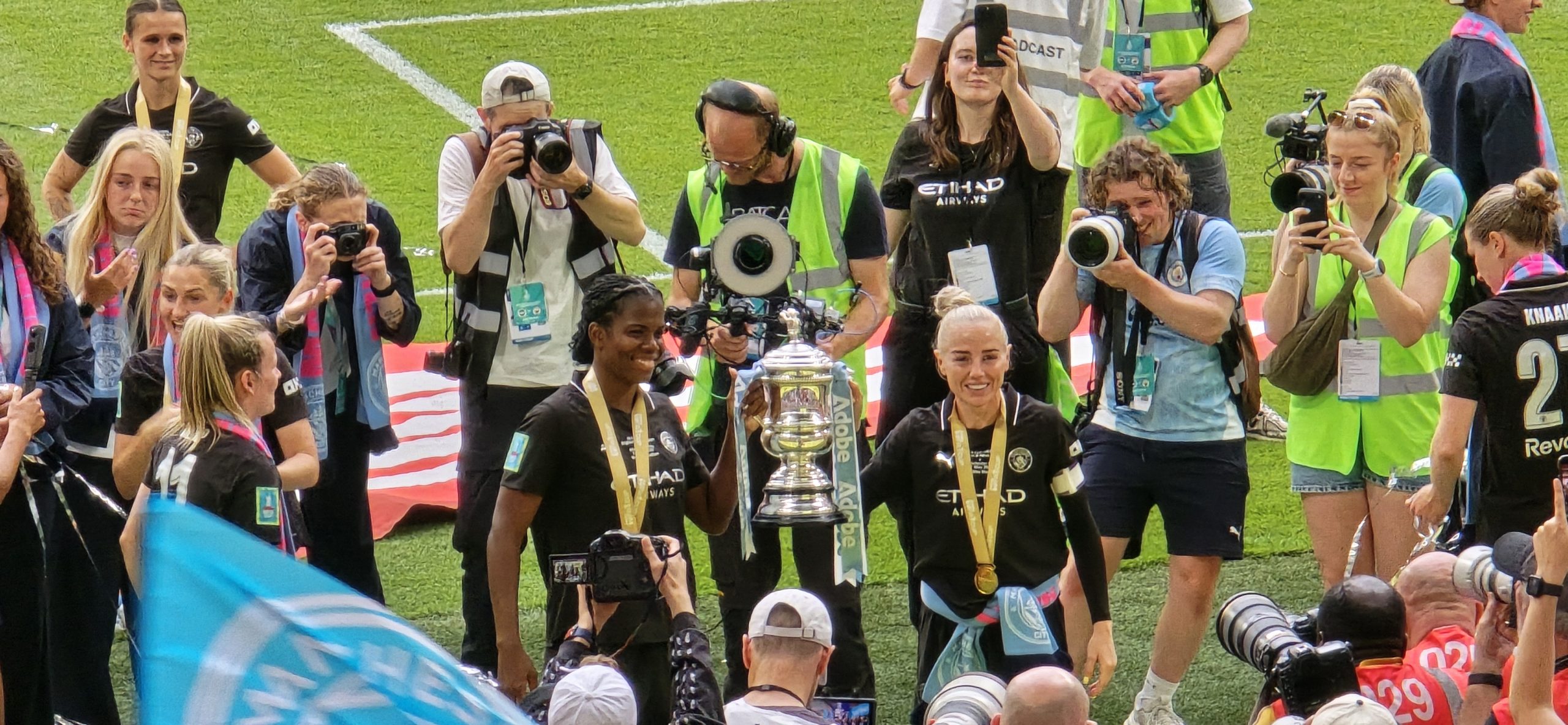 Photograph of Bunny Shaw and Alex Greenwood holding the Women's FA Cup at Wembley